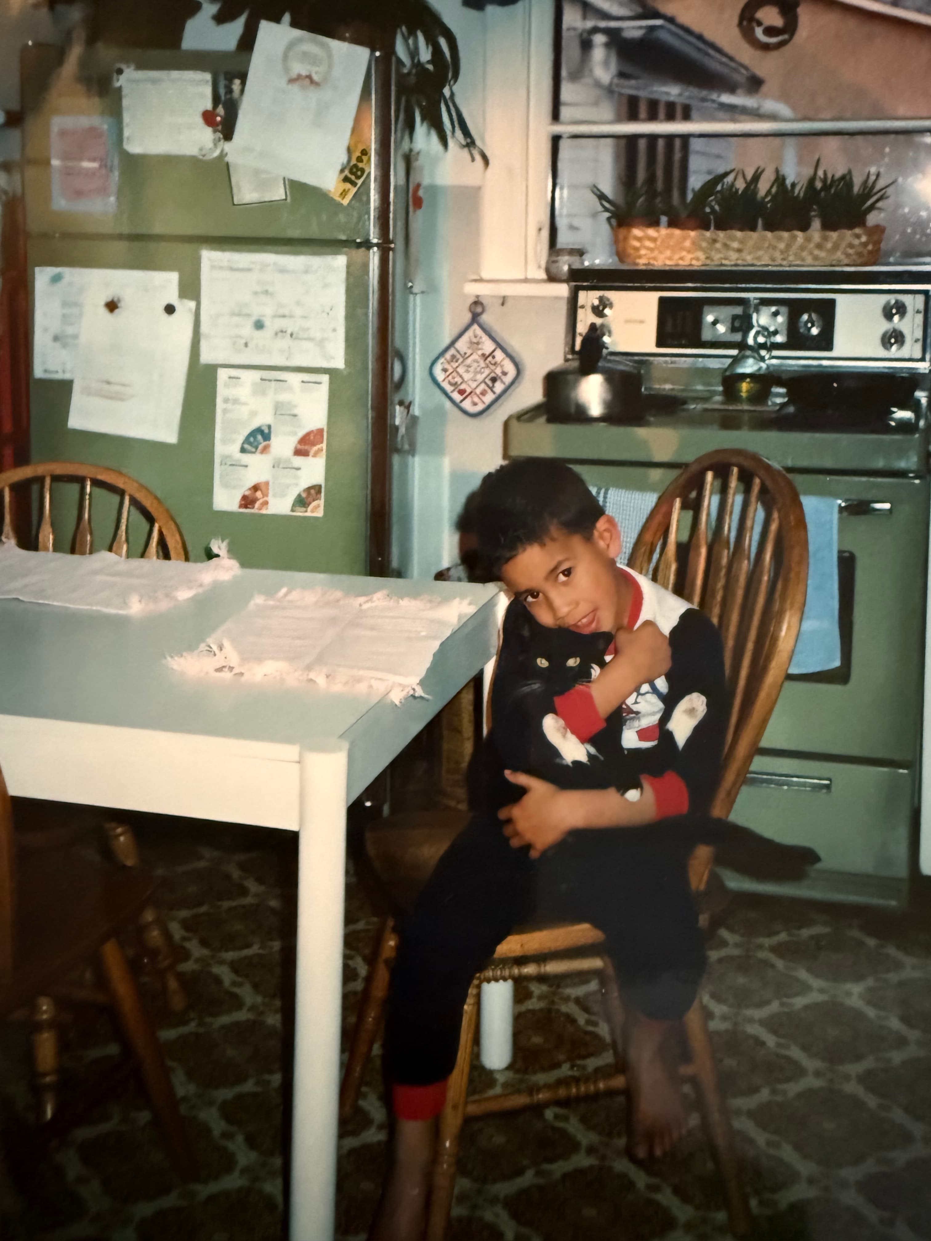 Moz as a kid with a cat